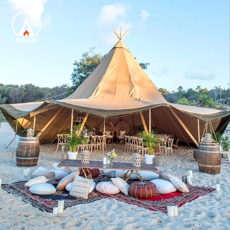 Tipi tent with open sides set up for an outdoor event on the beach Tipi tent with open sides set up for an outdoor event on the beach